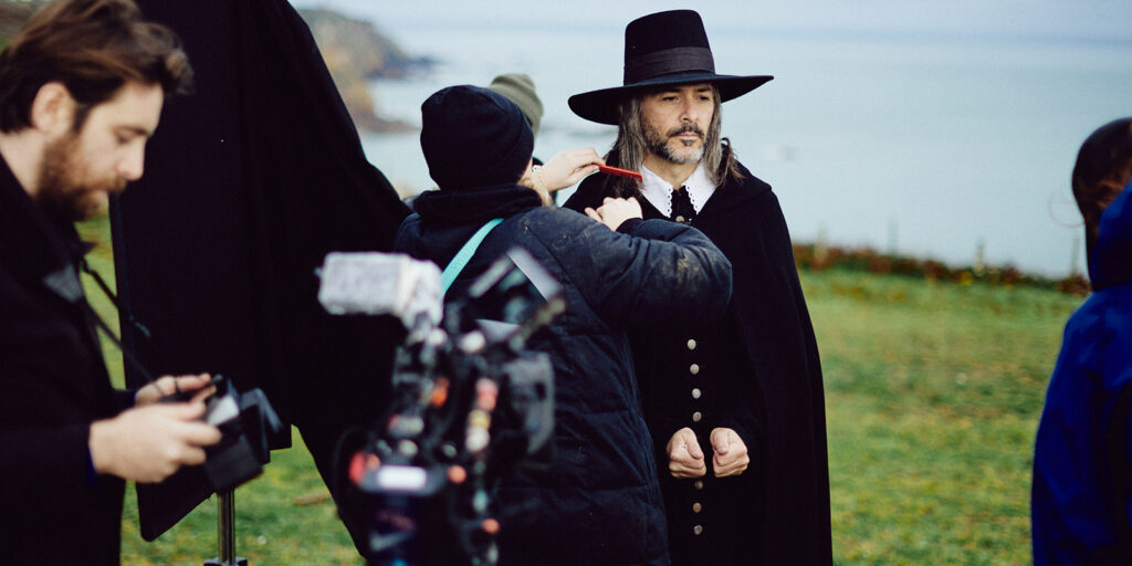 Film crew and an actor by the coast